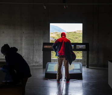 From the exhibition Heart of Iceland. A man stands on the exhibit piece "tectonic movements", where the tectonic plates are explained.
