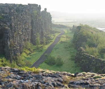 Almannagjá ( Everyman´s gorge) - seen to the north. Pathway in the middle of the gorge and visitors walking.