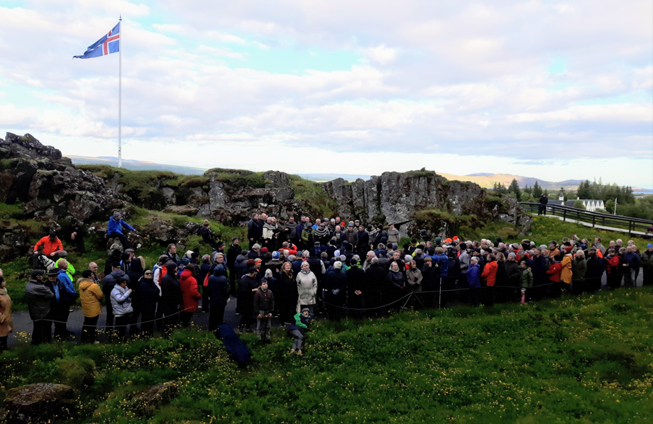 Margmenni við Lögberg í Almannagjá. Íslenski fáninn blaktir